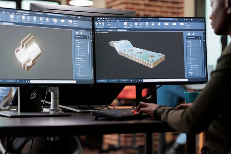 Manufacturing engineers designing tooling and production processes in CAD